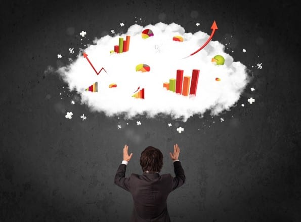 Businessman with charts in a cloud above his head