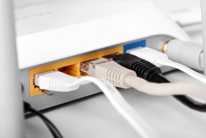 close up of internet wireless router with plugged cables